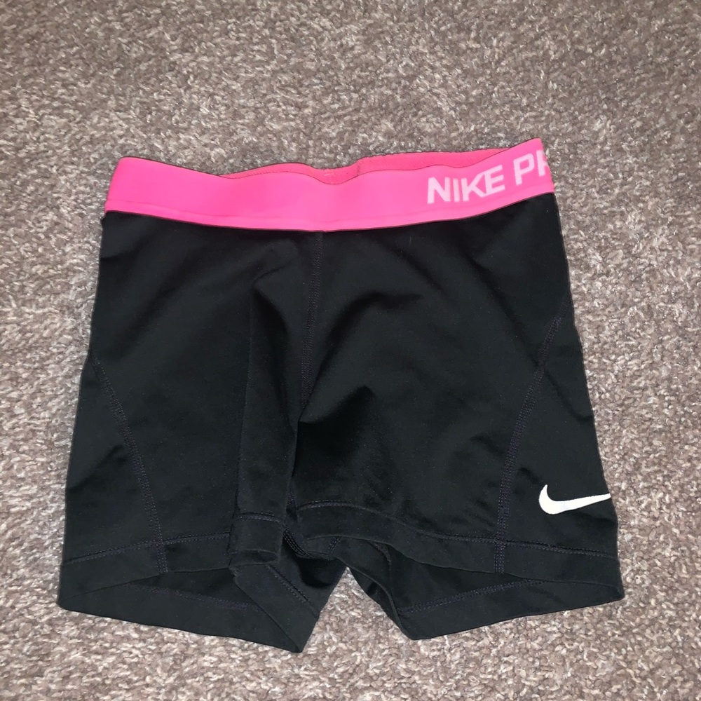 Black and pink Nike Pros